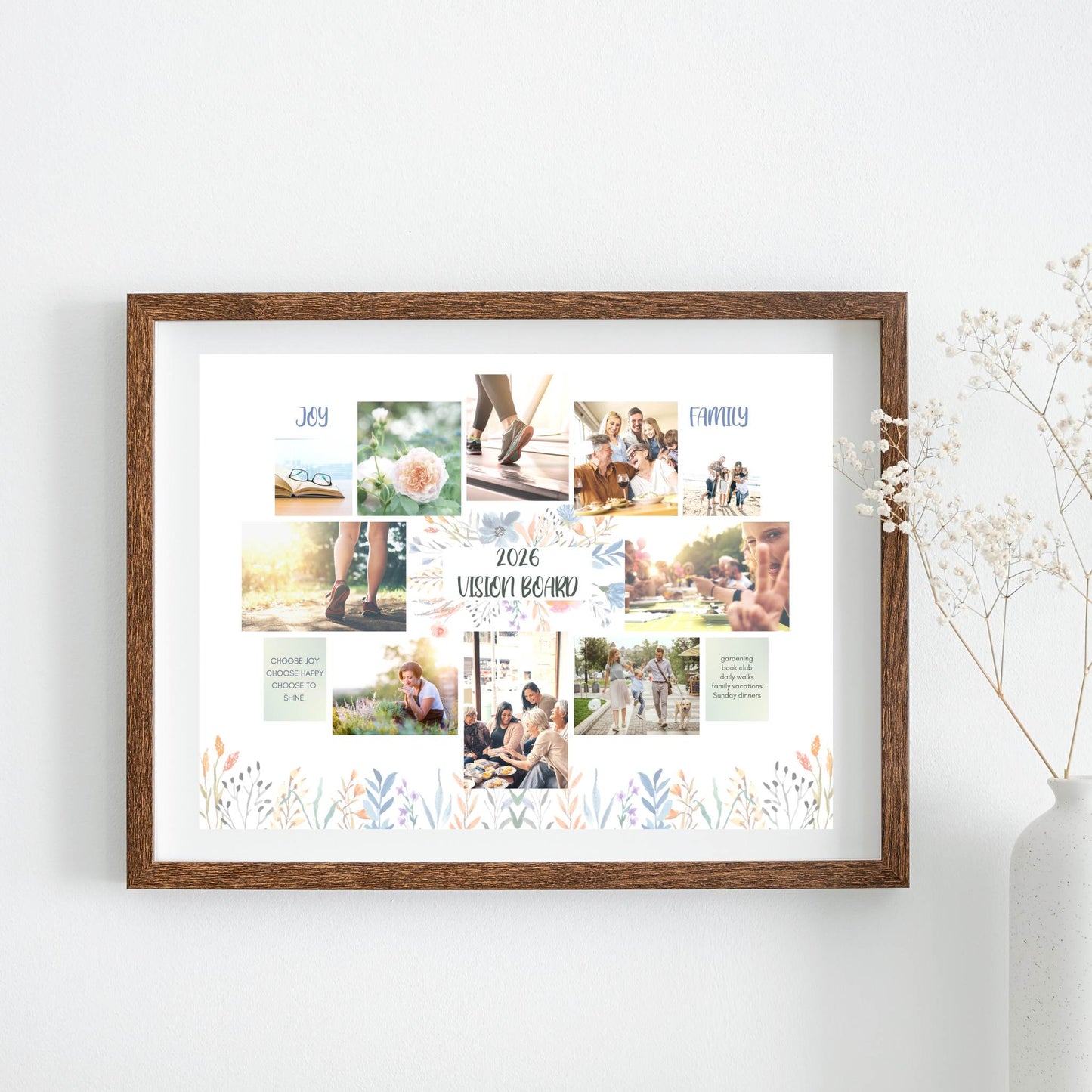 Framed Vision Board floral theme collage of photos and text on a white wall with a vase of flowers.