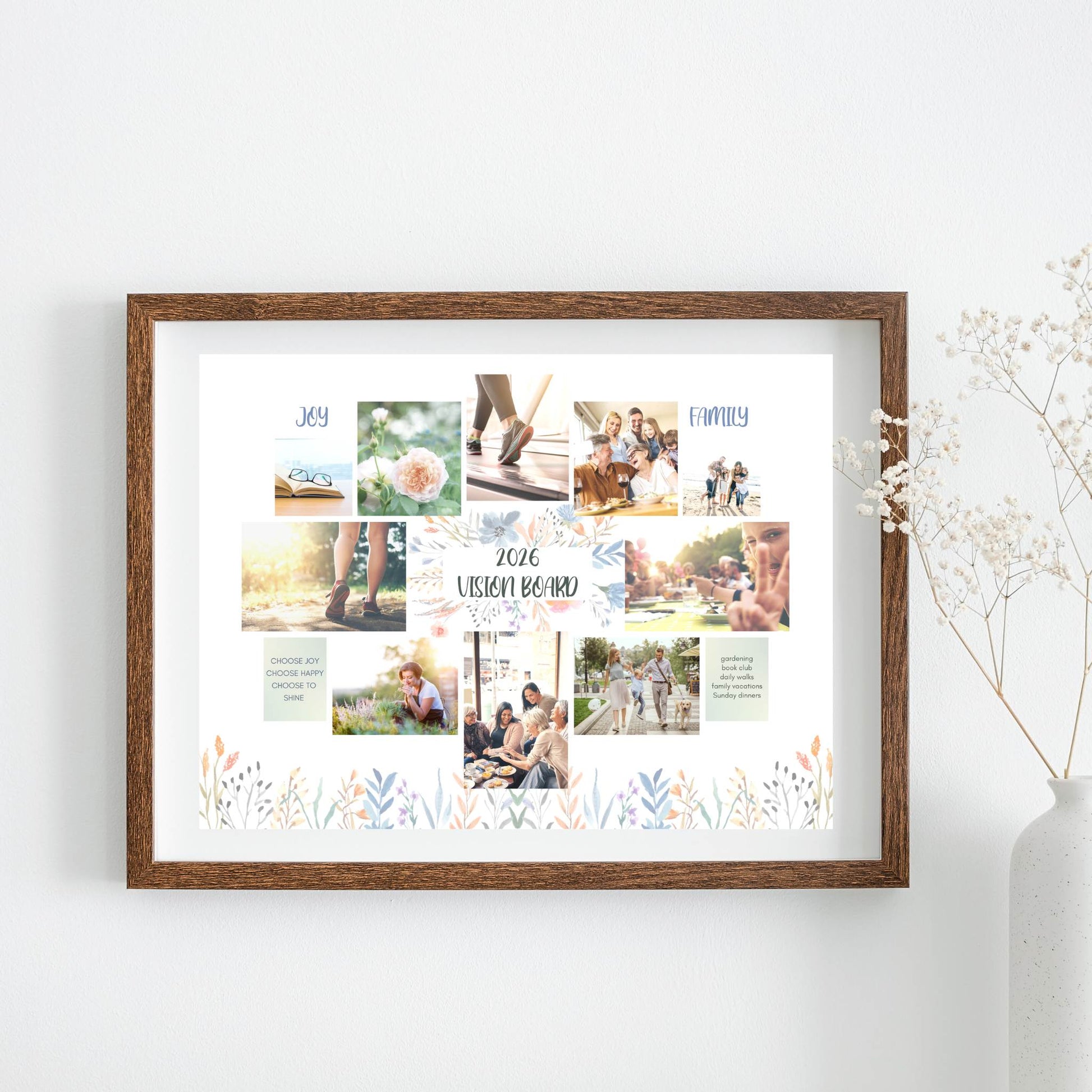 Framed Vision Board floral theme collage of photos and text on a white wall with a vase of flowers.